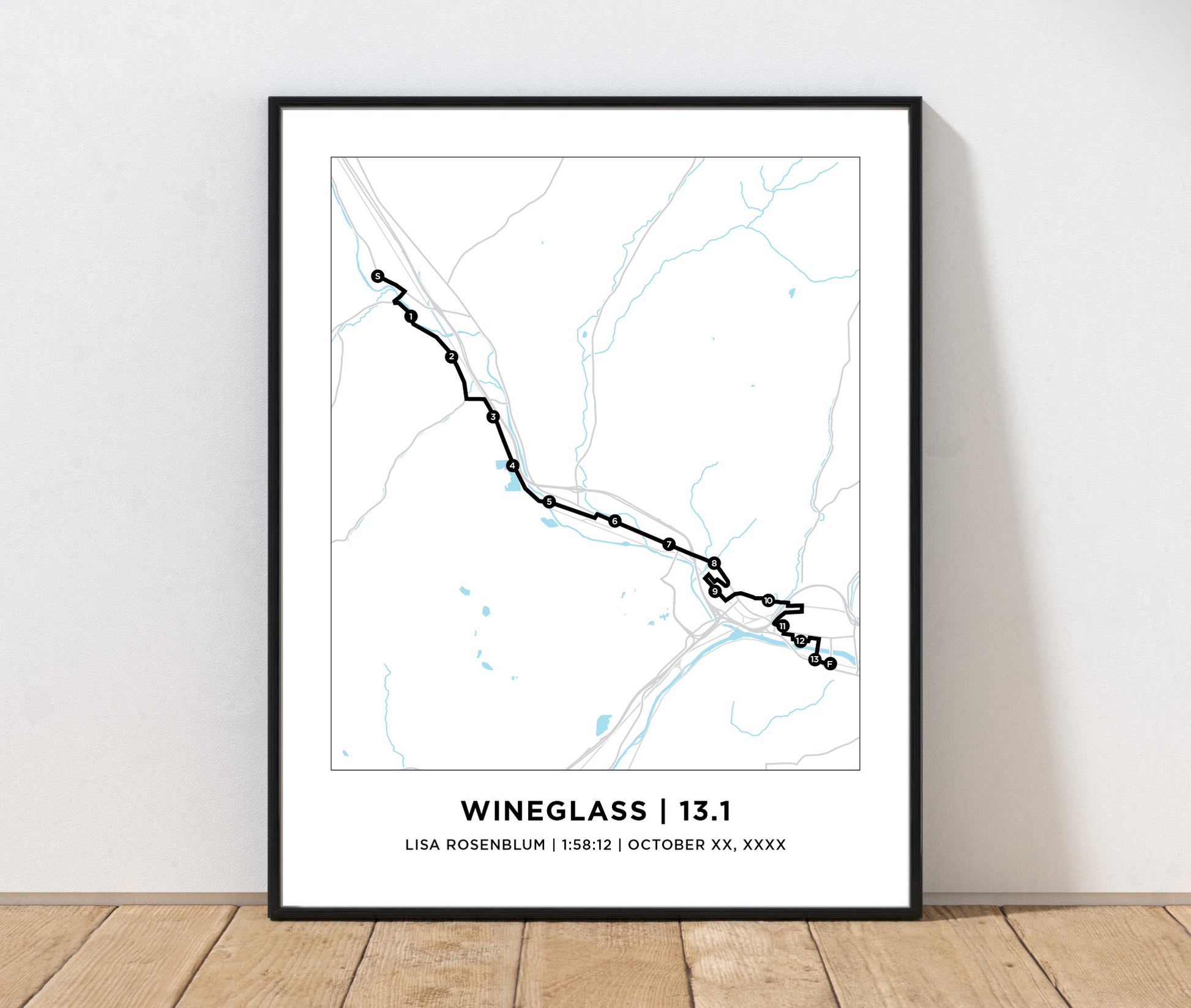 Framed map print of a running route titled 'Wineglass | 13.1' on a white wall.